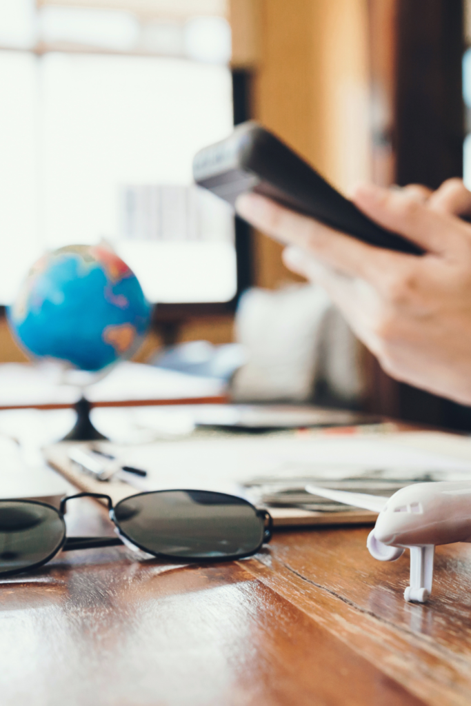 Person holding a cell phone, searching travel apps
